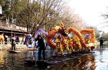 Villagers perform dragon dance on rafts in Zhejiang