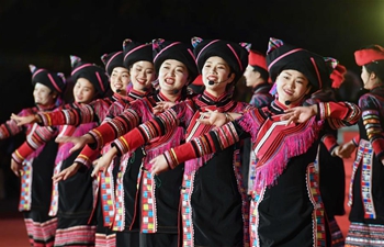 People perform during Spring Festival holiday in Pu'er City, SW China's Yunnan