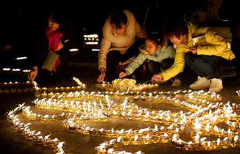 People light butter lamps to express good wishes in Xi'an