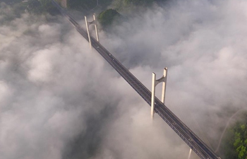 Aerial view of Gongshui River Bridge amid clouds and mists in China's Hubei