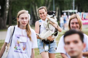 People play with dogs during "Day of Friends" charity festival in Moscow