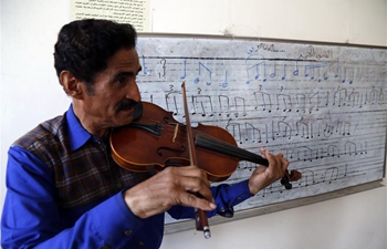 Yemeni music teacher persists in teaching young students for free