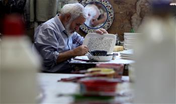 Palestinian artist works at glass, ceramics factory in West Bank city of Hebron