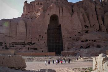 Tourists visit ruined Buddha statue in Bamyan province, Afghanistan