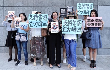 Citizens hold banners in support of police officers outside Hong Kong Police HQ