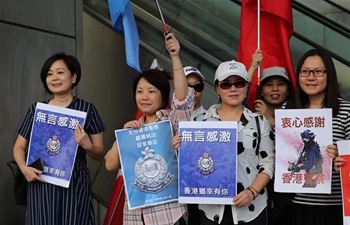 Citizens hold banners in support of police officers in Hong Kong