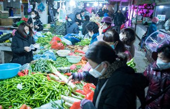 Citizens purchase vegetables at market in Wuhan