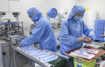 Workers make masks at medical supply company in Chongqing