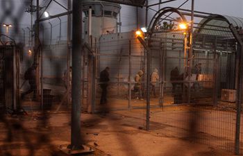 Palestinian workers cross Israeli checkpoint of Eyal to work in Israel