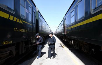 Staff members conduct train maintenance in Henan