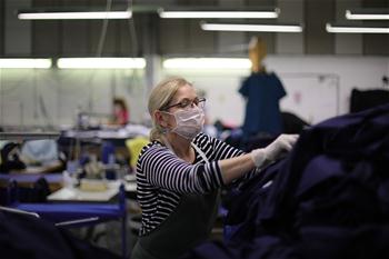 Workers make protective suits for NHS in London, Britain