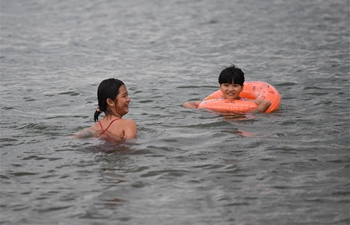 Citizens play in sea in Haikou