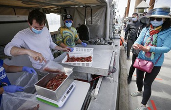 People buy fresh spot prawns in Richmond, Canada