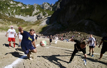 People play football on dried lake bottom in Croatia