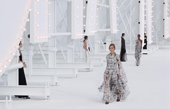 Models present creations by Chanel during Paris Fashion Week
