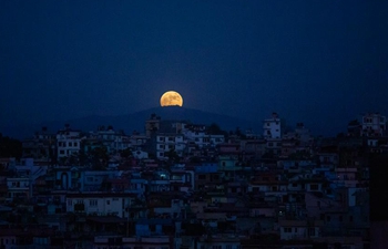 Full moon rises over Lalitpur, Nepal