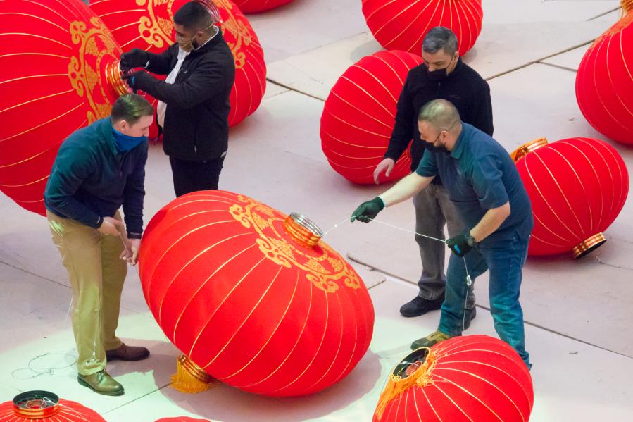 Staff members install red lanterns in Galleria Dallas shopping mall in Texas
