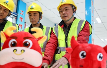 Workers celebrate upcoming Spring Festival at construction site in Guizhou