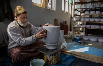 Workers conduct papier mache crafts at workshop in Indian-controlled Kashmir