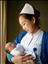 《晨曦》。2015年4月，妇产科病房。照片说明：清晨查房，护士在查看新生儿反应情况，两人沐浴在阳光下。（摄影 李路）