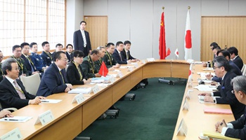 China urges Japan to stick to "purely defensive defense" strategy