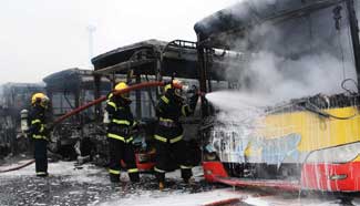 Firefighters put out fire at bus depot in China's Xiamen