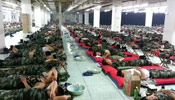 Firefighters of Tianjin rescue team sleep on floors