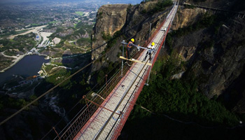 Hanging in the air: Workers risk life on suspension bridge