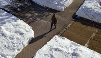 Residents in U.S. begin to shovel snow after monster winter storm