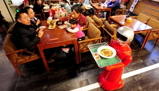 Robot works up to 8 hours of serving dishes in Shenyang restaurant