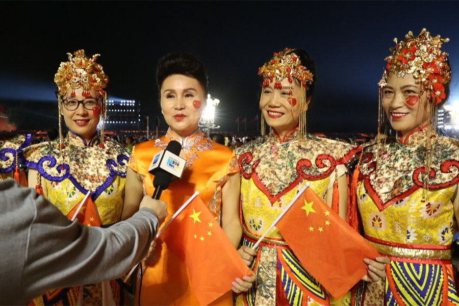 新华网记者现场采访参加国庆联欢活动的群众