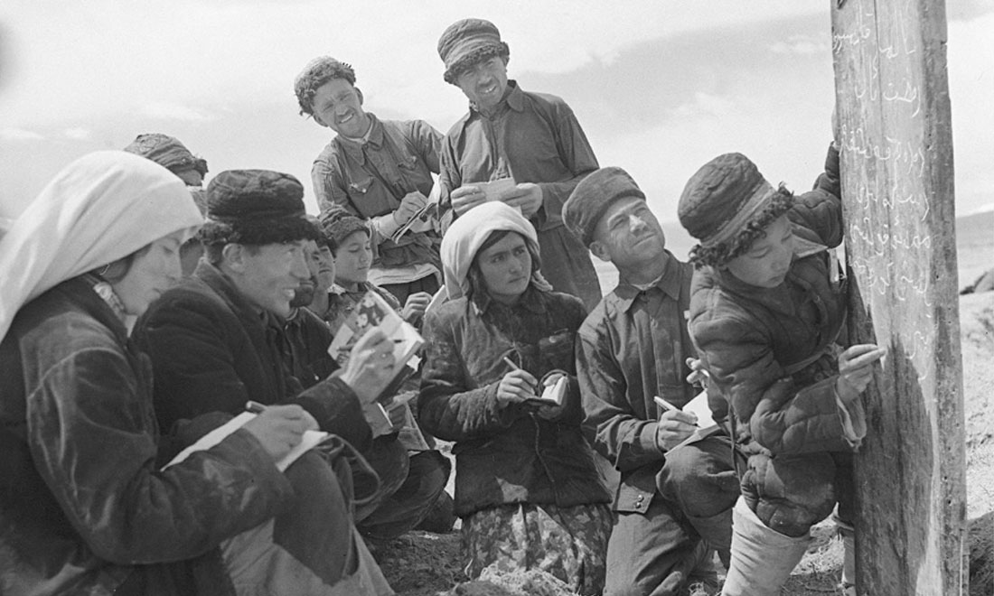 1960年6月，新疆慕士塔格峰下，大人们在小学生帮助下学习文化。新华社记者武纯展摄