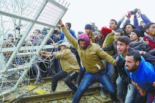 2月29日,在希腊与马其顿边境,难民从希腊一侧冲击边境 希腊成欧洲难民中心关卡。