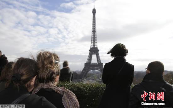 巴黎民众远眺埃菲尔铁塔,为在巴黎恐袭事件中的遇难者默哀。