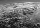 NASA发布冥王星近景图 凹坑与冰川清晰可见