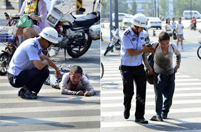 交警烈日下苦劝假装残疾乞丐起身