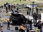 沙特联军空袭也门首都 卡车遭袭致食用油桶落满地（高清组图）