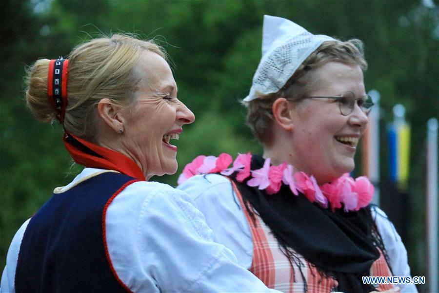 people dance on eve of midsummer day in helsinki, finland