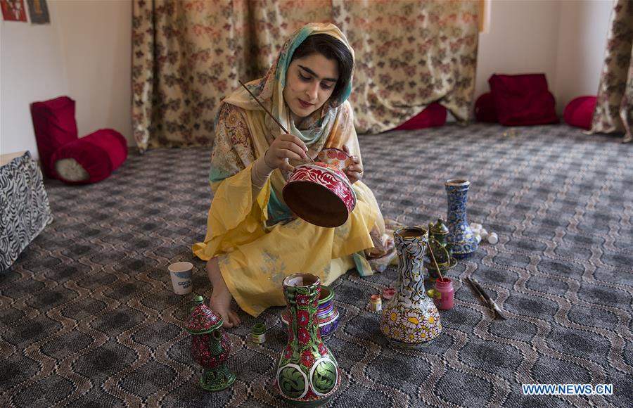 artist shafiya shafi paints on earthen pot in srinagar city