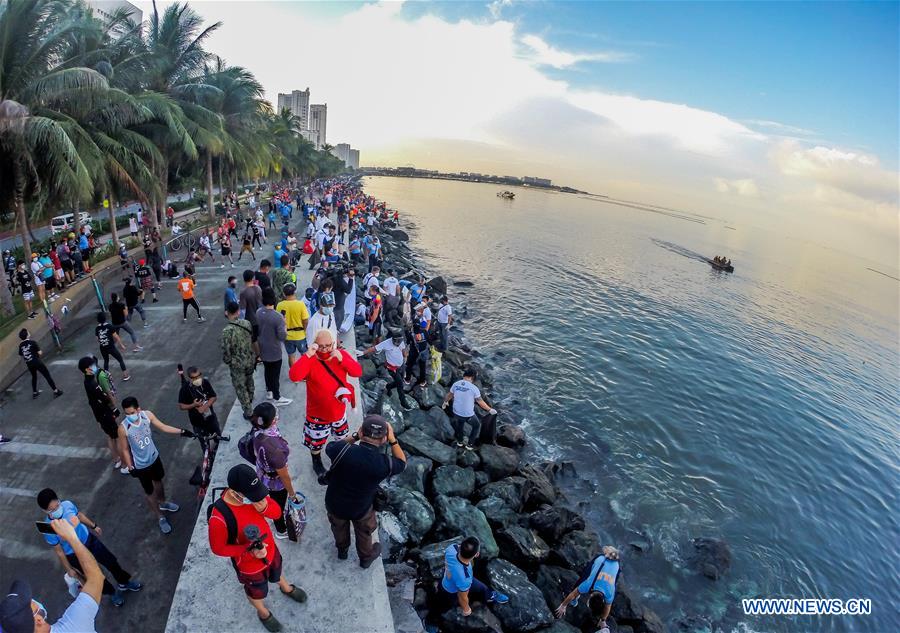 Volunteers collect rubbish along coast of Manila Bay in the Philippines ...
