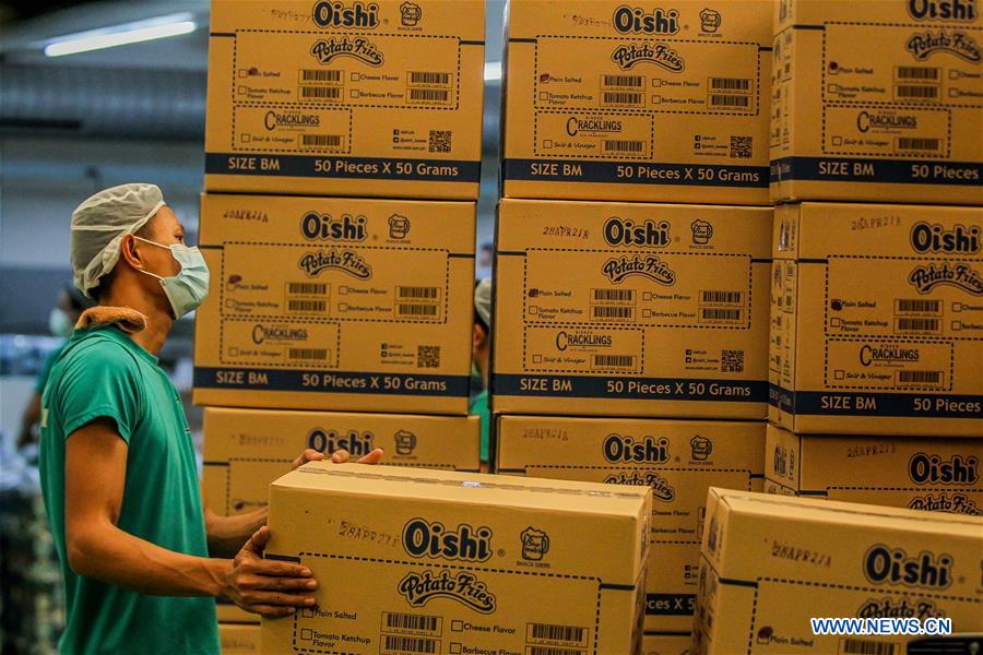 workers sort packs of products in cavite province, the