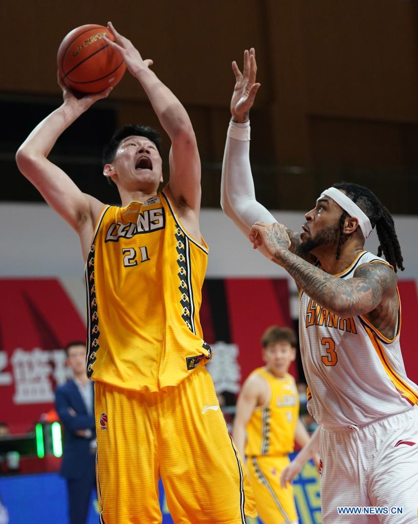 hu jinqiu (l) of zhejiang lions goes to the basket against eric