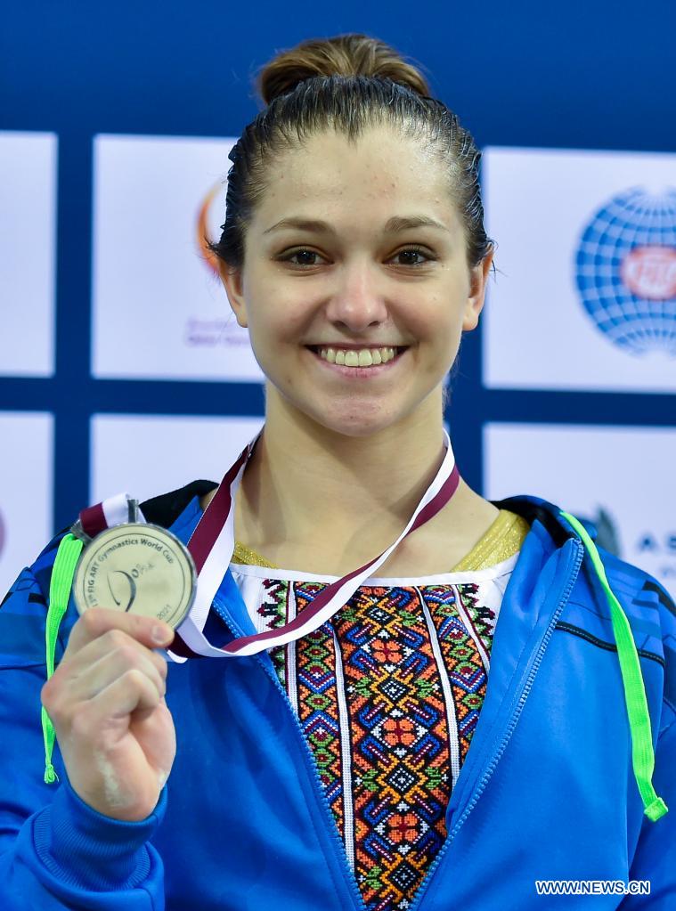 poses during the awarding ceremony for the womens uneven bars
