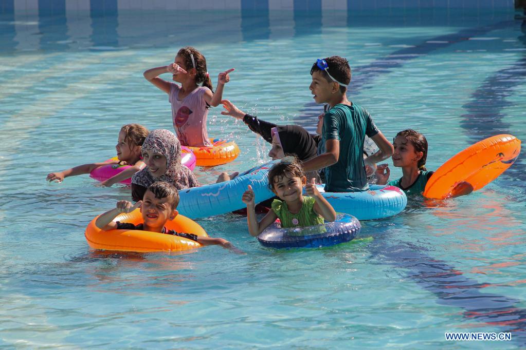 palestiniansplayinpooltocooloffduringhotday