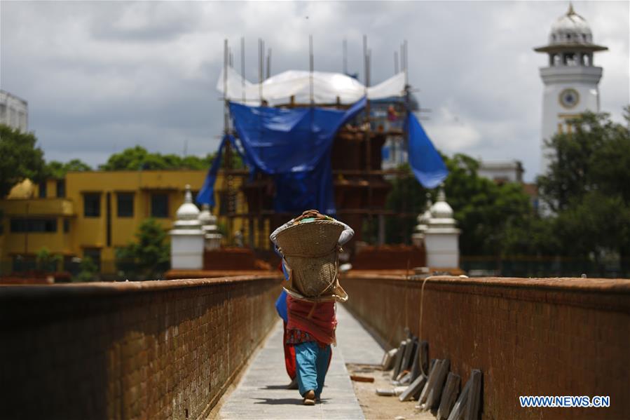 people work at reconstruction site of rani pokhari pond in