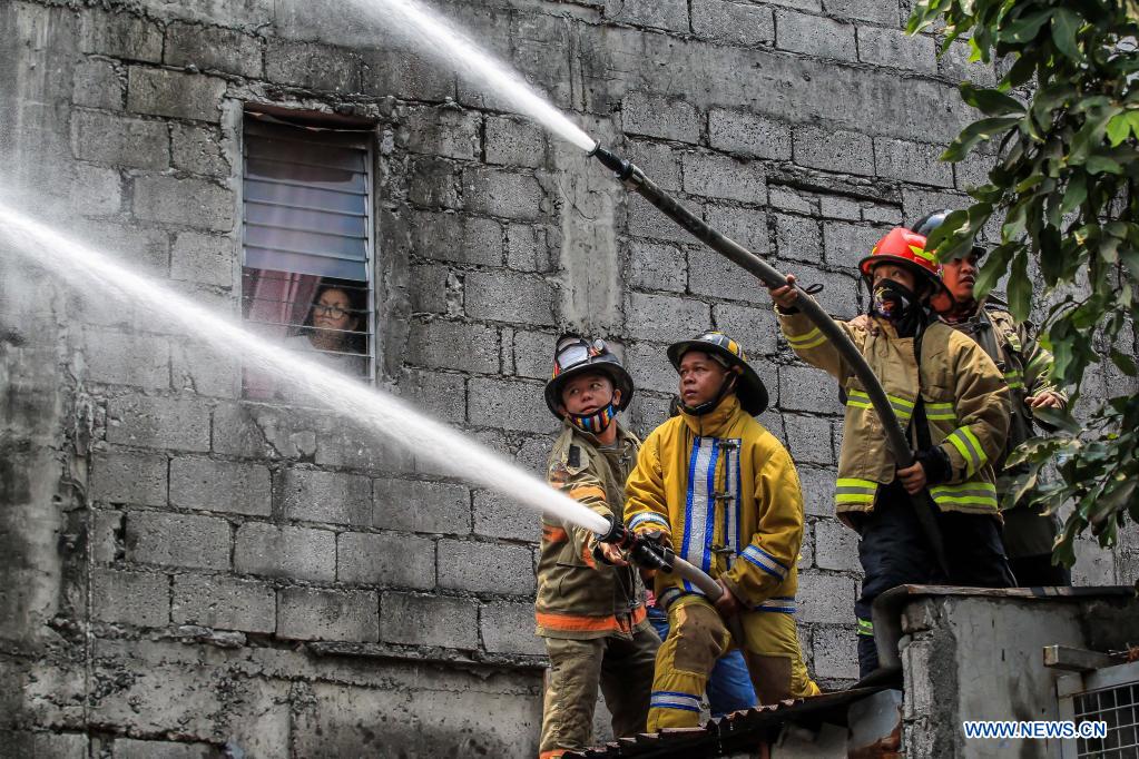 firefighters try to put out fire engulfing residential area in