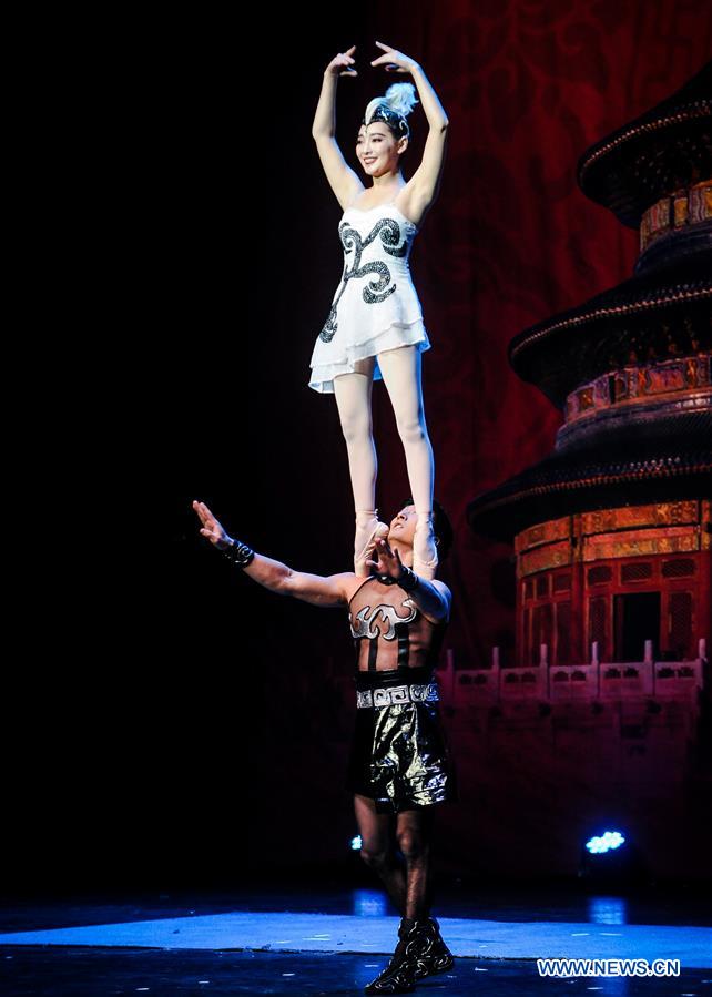 artists perform acrobatics to celebrate upcoming chi