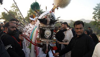 Pakistani Shiite Muslims attend procession on 9th day of Muharram