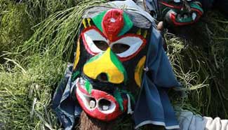 Villagers perform in costumes of "Mang Ge" during local festival in south China