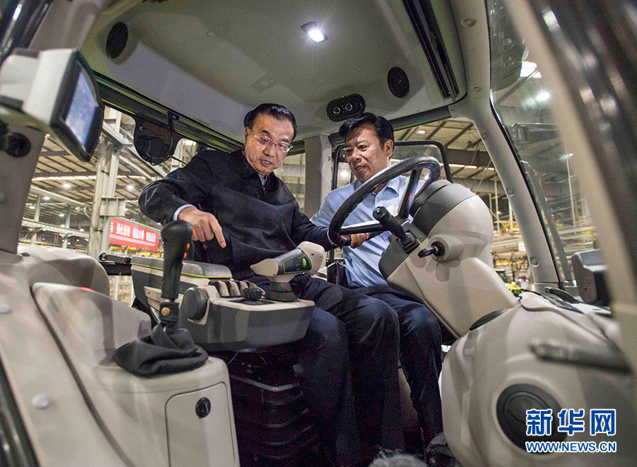 5月8日至9日，中共中央政治局常委、国务院总理李克强在河南开封、新乡、郑州考察。这是5月8日，李克强在中联重科生产车间听取企业负责人介绍企业开展大马力拖拉机集成制造的情况汇报。新华社记者 李涛 摄